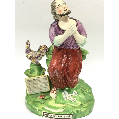 1292 - A 19th century Staffordshire pearl ware figure of Saint Peter. 21cm tall