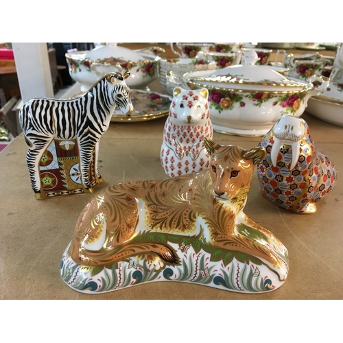 1294 - Four Royal Crown Derby paperweights in the form of Lioness, bear, walrus and zebra. All with stopper... 