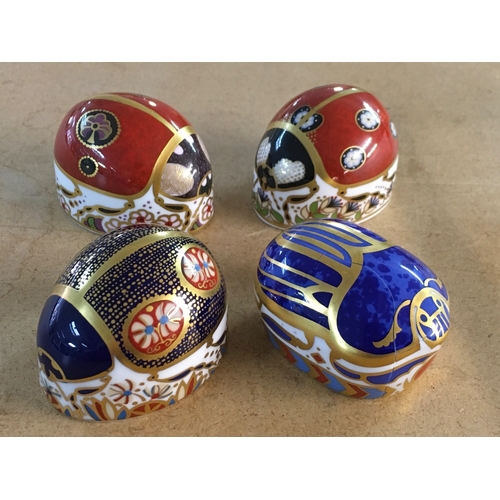 1298 - Four Royal Crown Derby paperweights in the form of beatles, including Scarrab Beatle - with damage.