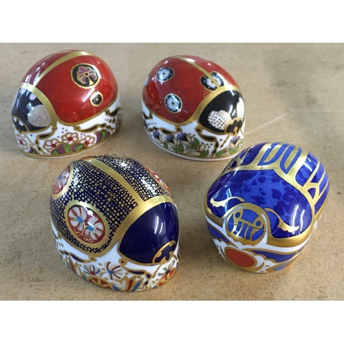 1298 - Four Royal Crown Derby paperweights in the form of beatles, including Scarrab Beatle - with damage.