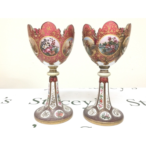 1398 - A pair of Victorian cranberry glass and enamel lustres (damaged). 26cm tall