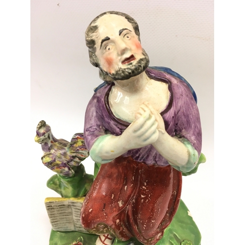 1292 - A 19th century Staffordshire pearl ware figure of Saint Peter. 21cm tall