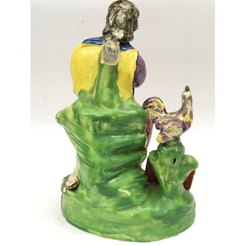 1292 - A 19th century Staffordshire pearl ware figure of Saint Peter. 21cm tall