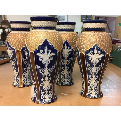 1299 - Four Royal Doulton Lambeth stoneware vases, decorated with stylised foliage. Some A/F. All 28cm in h... 
