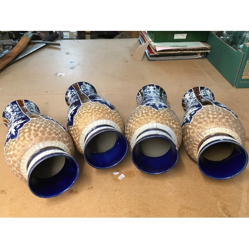 1299 - Four Royal Doulton Lambeth stoneware vases, decorated with stylised foliage. Some A/F. All 28cm in h... 