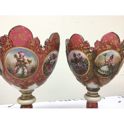 1398 - A pair of Victorian cranberry glass and enamel lustres (damaged). 26cm tall
