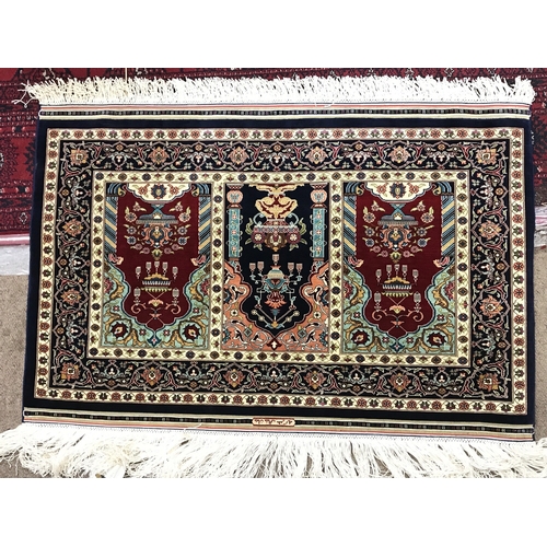 2344 - A small silk Turkish Hereke rug. 80x54cm