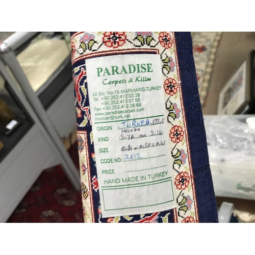 2344 - A small silk Turkish Hereke rug. 80x54cm