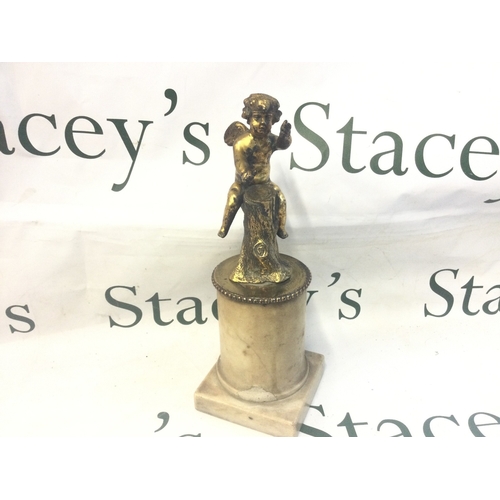 853 - A gilt mounted putti on a marble base, 28cm tall