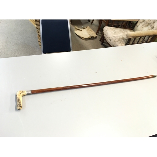 858 - A sword stick with a silver hallmarked collar and a antler fritz handle. 91cm long. Blade 40cm long