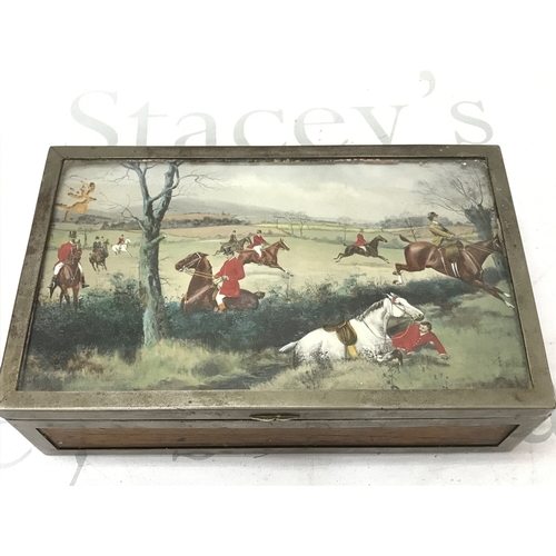 865 - A Silver-plated cigar box featuring a hunting scene painting under glass on the lid. Dimensions 23.5... 