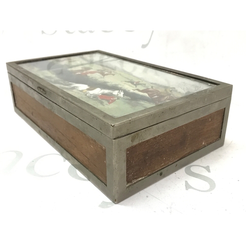 865 - A Silver-plated cigar box featuring a hunting scene painting under glass on the lid. Dimensions 23.5... 