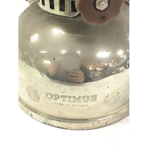870 - A vintage Swedish Optimus chrome kerosene lamp with a red top. 42cm tall NO RESERVE