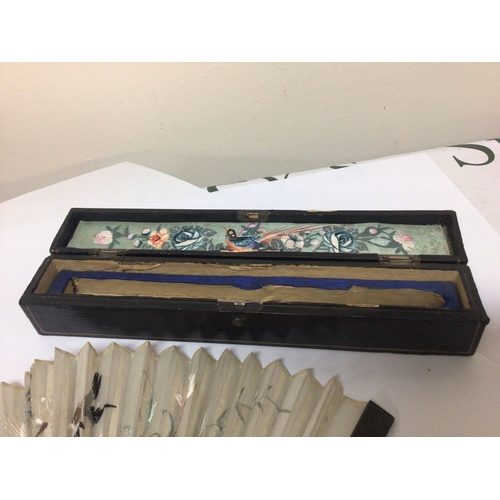 899 - A 19th century tortoiseshell and silk embroidered fan in a lacquer box with a hand painted panel. Go... 