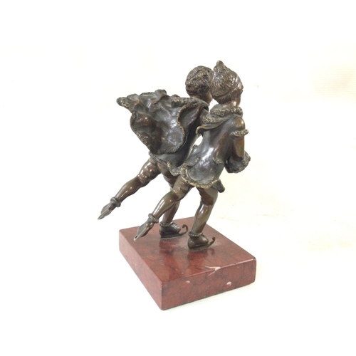 907 - A small bronze early 20th century skating figure on a marble base. 17cm tall
