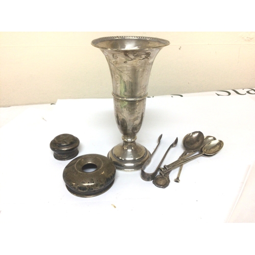908 - A Silver vase with loaded base a quantity of silver spoons and silver tidy jar lids.