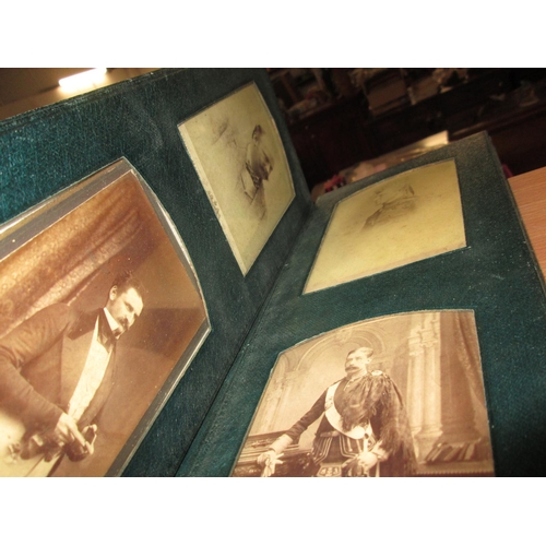 24 - Early 20th century family photographs in green leather fold out album