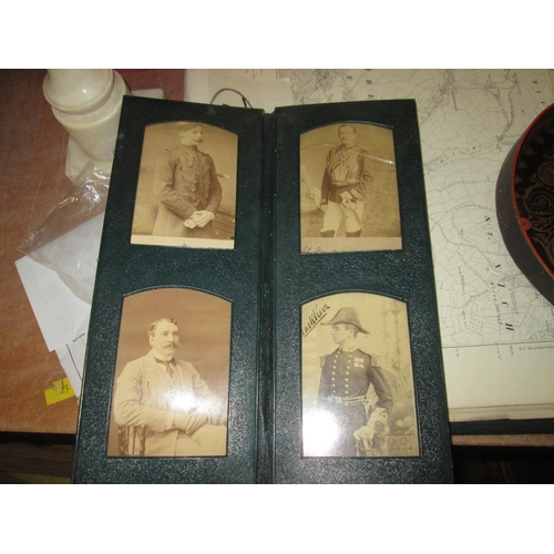 24 - Early 20th century family photographs in green leather fold out album