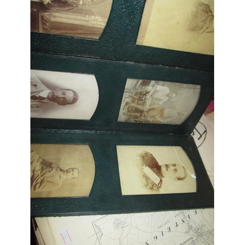 24 - Early 20th century family photographs in green leather fold out album