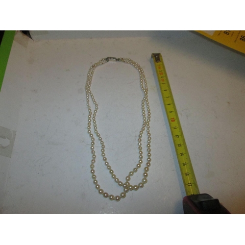 80 - Double strand pearl necklace with unmarked white and yellow gold clasp set with three diamonds