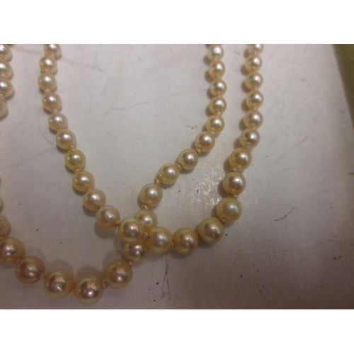 80 - Double strand pearl necklace with unmarked white and yellow gold clasp set with three diamonds