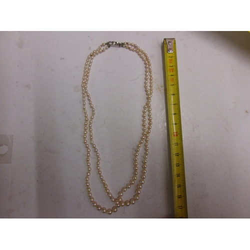 80 - Double strand pearl necklace with unmarked white and yellow gold clasp set with three diamonds