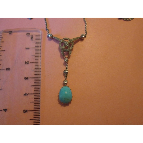 103 - Very pretty unmarked white gold Art Deco style pendant  set with graduated diamonds with a turquoise... 