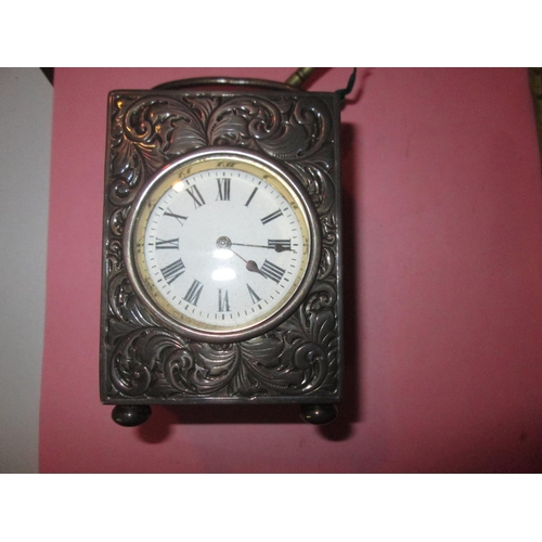 123 - Good quality striking carriage clock in silver case, scrolling acanthus leaf decoration throughout w... 