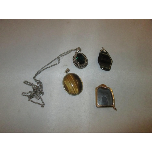 128 - 4 x hardstone pendants, set in silver and gold plate : Tigers eye, agate, coloured glass