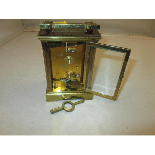 282 - Late 19th / early 20th century carriage clock with painted dial, bevelled glass and gilded brass cas... 