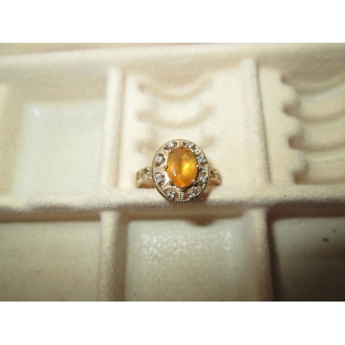 433 - 9 ct gold ring set with oval topaz surrounded by small chip diamonds size  N (54) 3 g