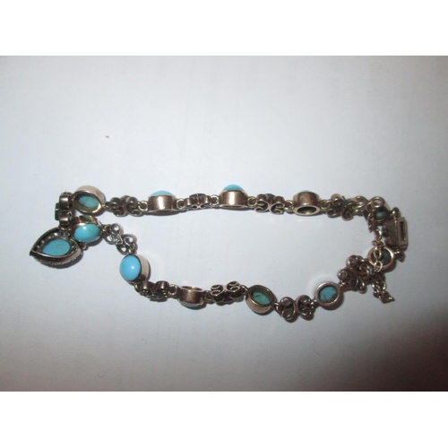 99 - A pretty but unmarked 9 ct gold open link bracelet set with turquoise and diamonds and a heart shape... 