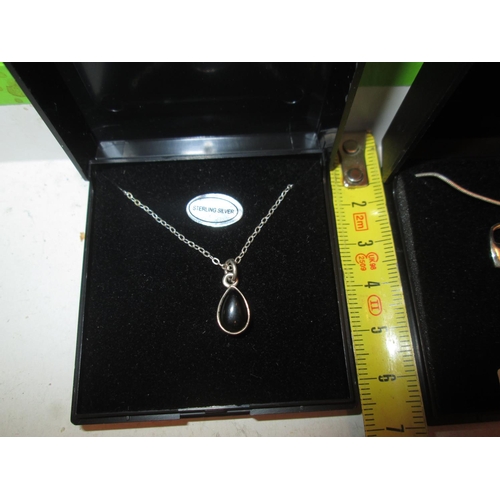 72 - Silver and black stone pendant on silver chain in presentation box