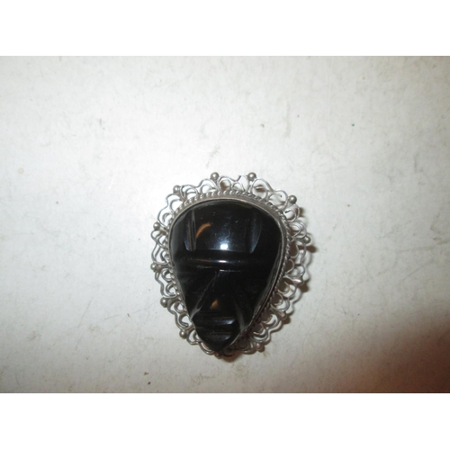 112 - Silver brooch inset with carved hardstone