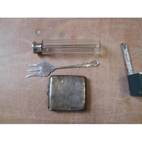 58 - Silver cigarette case note dings, silver fork with rubbed marks and silver lidded scent bottle 140 g