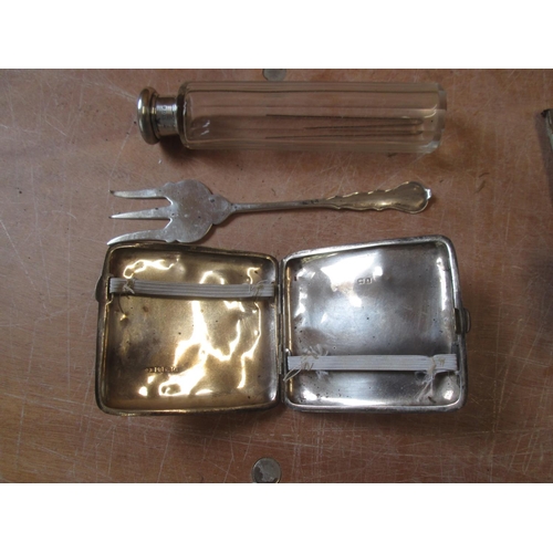 58 - Silver cigarette case note dings, silver fork with rubbed marks and silver lidded scent bottle 140 g