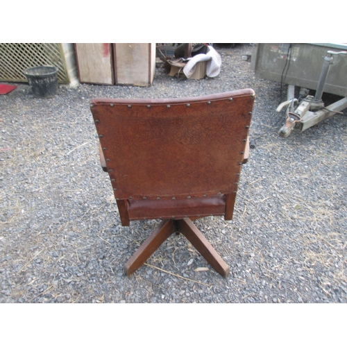 455 - Early 20th century oak and leather revolving office chair with makers mark, leather split on front