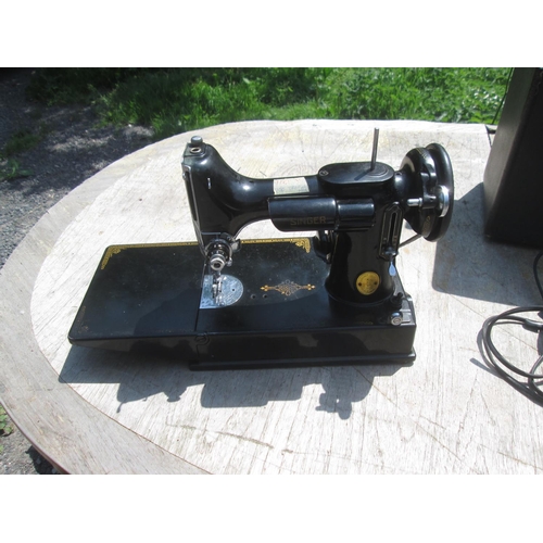 470 - Singer sewing machine Model 221 K in hardboard case, some gild wear, with treadle and some accessori... 