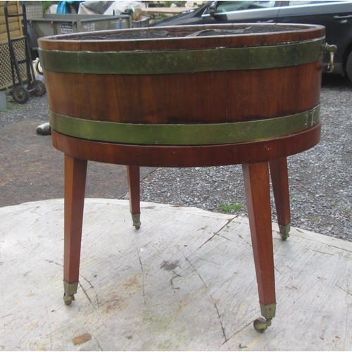 92 - Georgian mahogany wine cooler, with lift off top with partial lead lining on oval base with square t... 