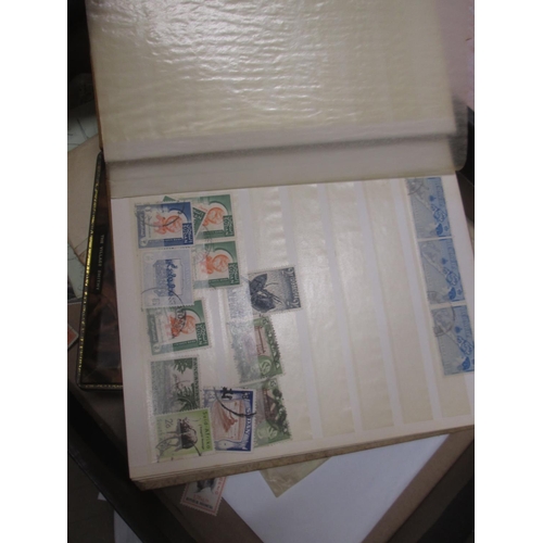 4 - A quantity of stamp duplicates in a small stock book, higher value stamps from 1954 Rhodesia & Nyasa... 