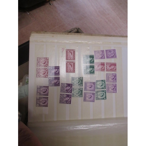 4 - A quantity of stamp duplicates in a small stock book, higher value stamps from 1954 Rhodesia & Nyasa... 