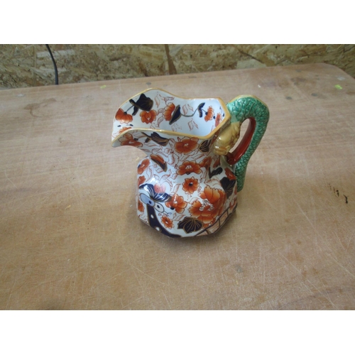 64 - Snake handle pottery jug