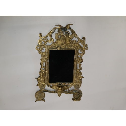 282 - 20th century brass frame mirror decorated with cherubs 35 cms x 24 cms
