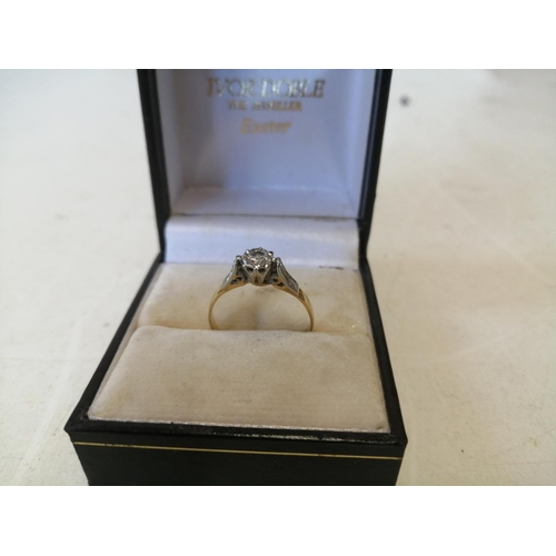 124 - 18 ct gold ring with solitaire diamond in raised platinum set with two further diamonds down the sha... 