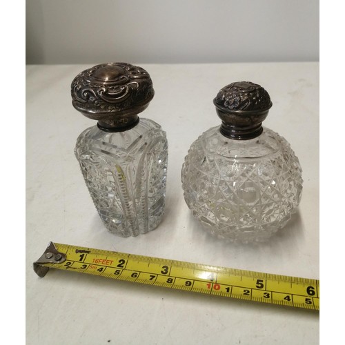 132 - 2 x silver top cut glass scent bottles, note push in on top