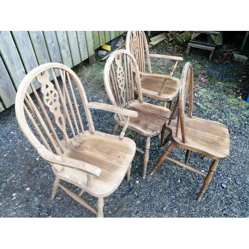 138 - Set of four 20th century wheelback chairs including two carvers