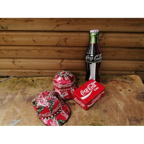 214 - Coca Cola Advertising Collectables : tin sign, empty and full plastic and glass bottles, wristwatch ... 