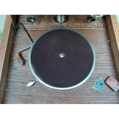 575 - Edephone floor standing wind up gramophone in oak case, working order with crank, case top needs att... 