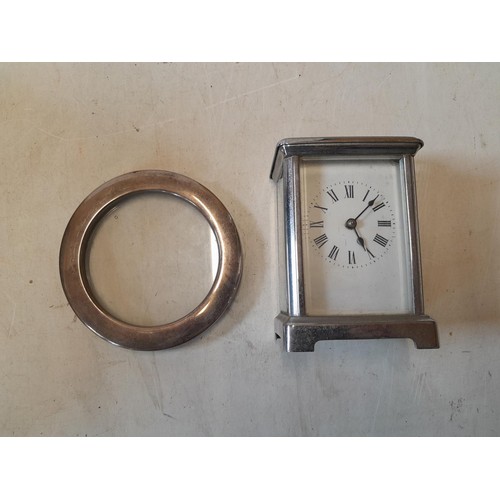 279 - Silver circular photograph frame and plated carriage clock