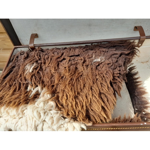 109 - 2 x vintage suitcases & 2 x sheepskin rugs